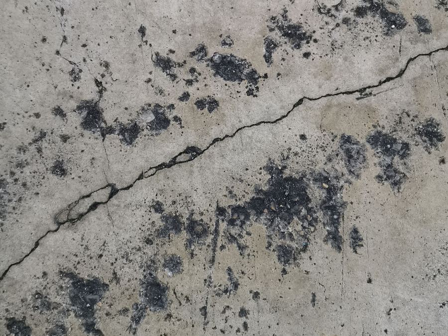 Cracked, stained bare concrete slab