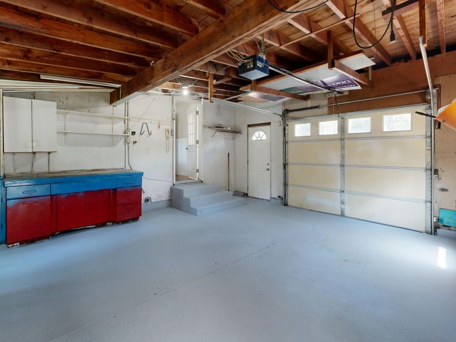 Garage with an overhead door and smooth coated floor