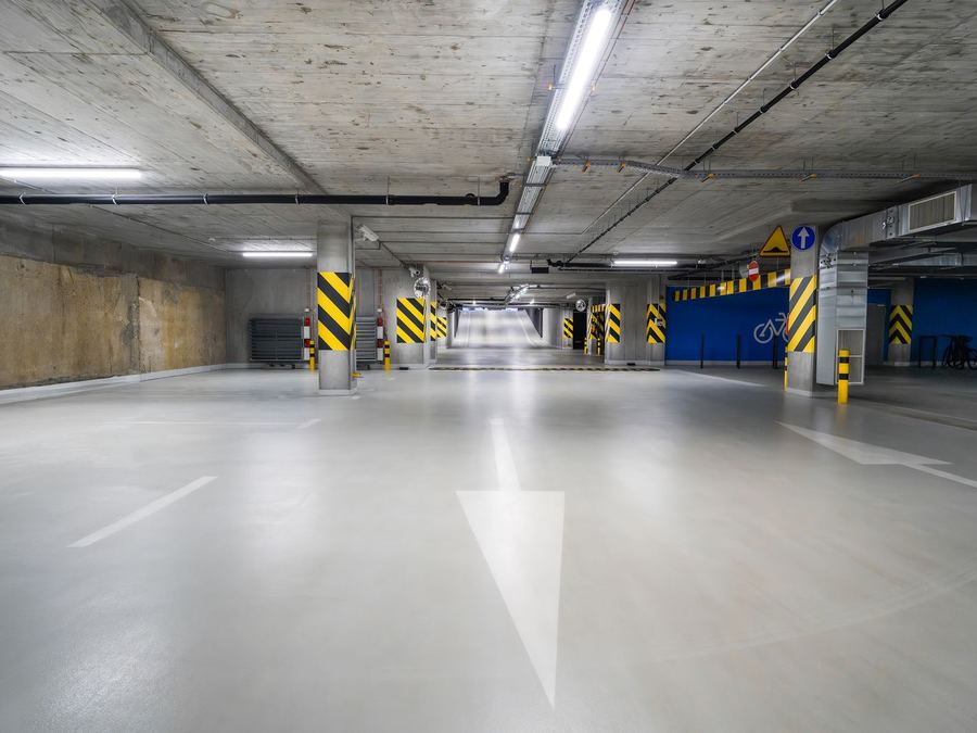 Parking structure with a smooth coated concrete floor