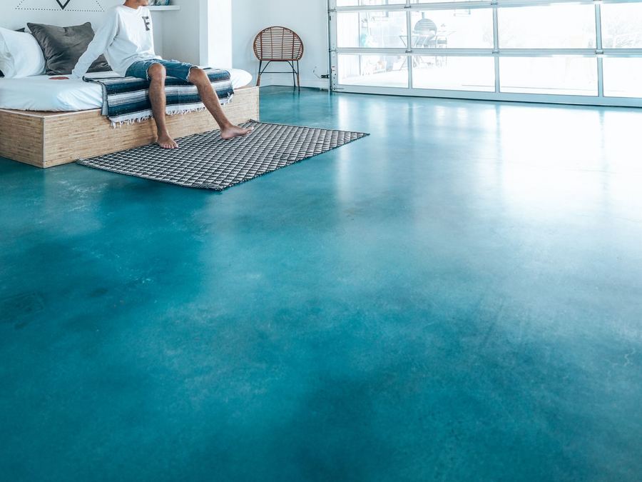 Glossy turquoise floor in a bright loft-style space